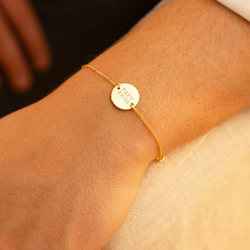 Médaille brillante et ses deux trous délicats, ce bracelet en plaqué or ajoute une touche de sophistication à votre look. Une chaîne maille fine complète ce bijou personnalisé.