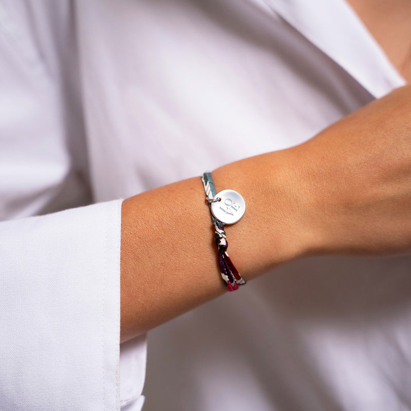 Un bracelet argenté personnalisé, arborant une médaille de 15mm et un délicat lien Liberty Jacinthe.