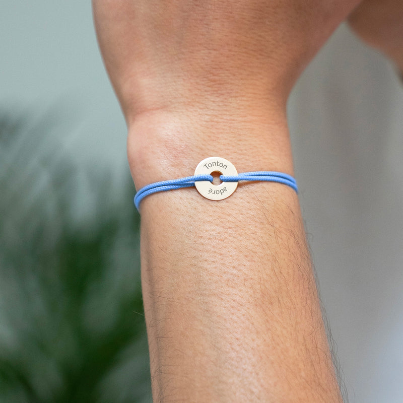 Un bracelet élégant en forme de cible, personnalisé en 15mm, plaqué or, accompagné d'un cordon bleu pastel.