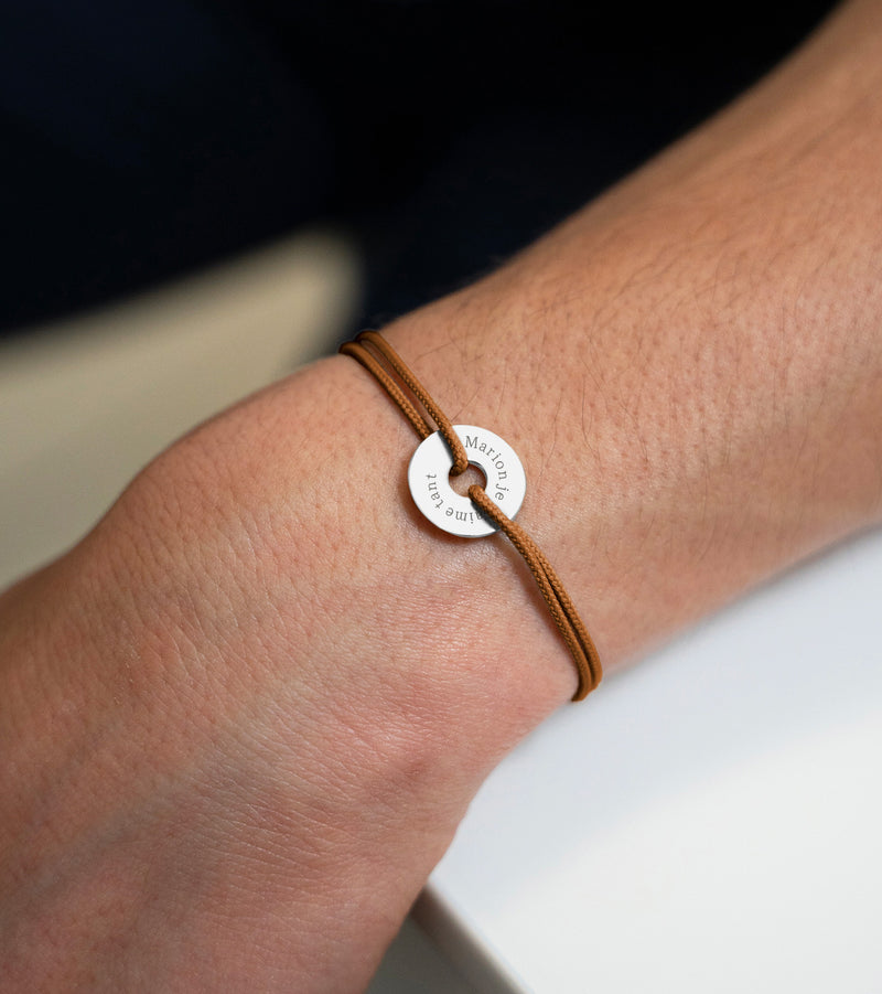 Avec un cordon marron clair, ce bracelet en forme de cible est personnalisé de 15mm en argent.