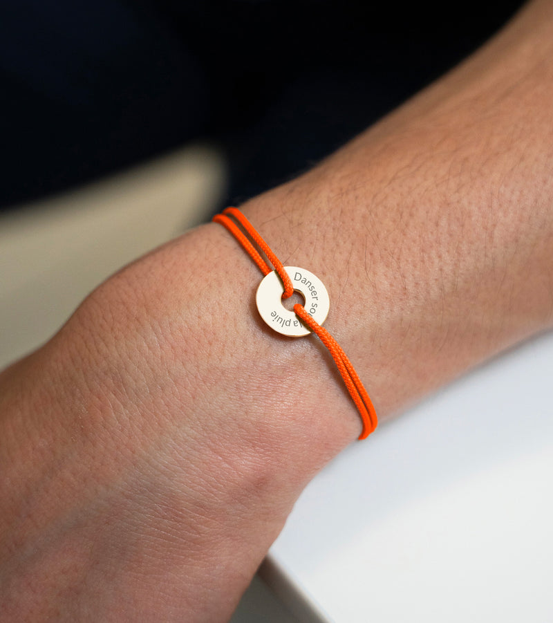 Un bracelet en forme de cible, personnalisé en 15mm, plaqué or, avec un cordon orange fluo