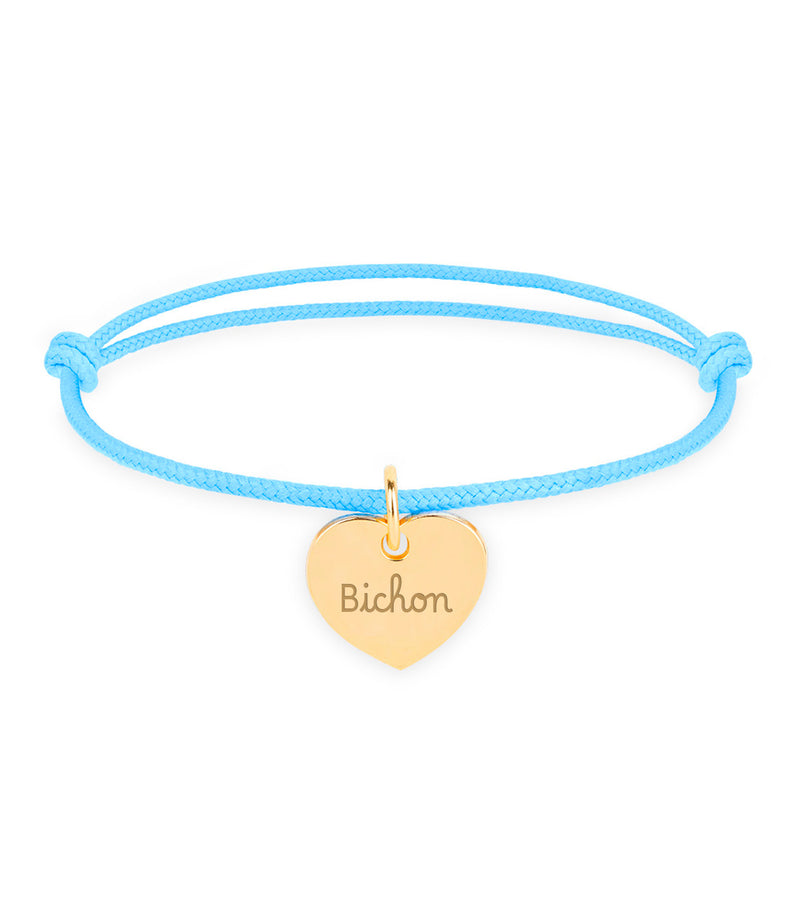 Découvrez ce bracelet exquis, arborant un cœur plaqué or de 15mm, suspendu avec élégance sur un cordon bleu pastel, ajoutant une touche de sophistication à votre style.