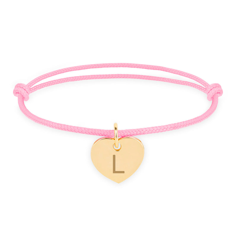 Bracelet en or avec un cœur, pour une touche d'élégance, avec un cordon rose.
