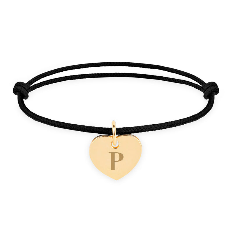 Un bracelet en plaqué or avec un cordon noir pour un style classique.