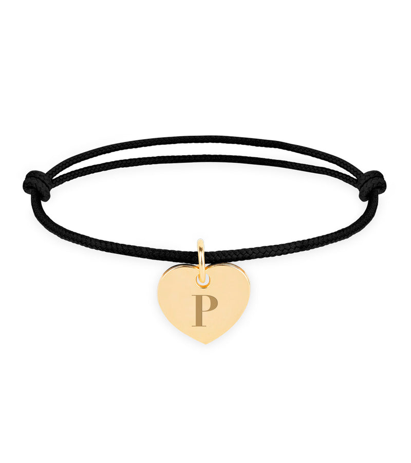 Un bracelet en plaqué or avec un cordon noir pour un style classique.