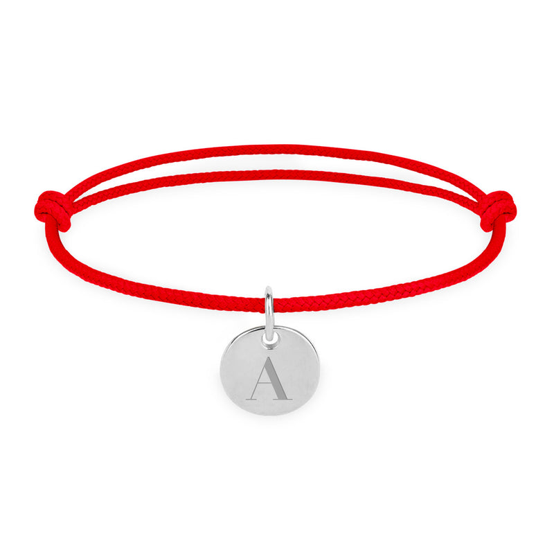 Un bracelet personnalisé en argent, avec une médaille de 10mm et un cordon rouge.
