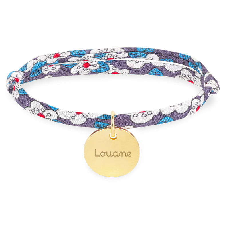 Élégant bracelet avec une médaille plaquée or de 15mm, agrémenté d'un lien Liberty Iris.