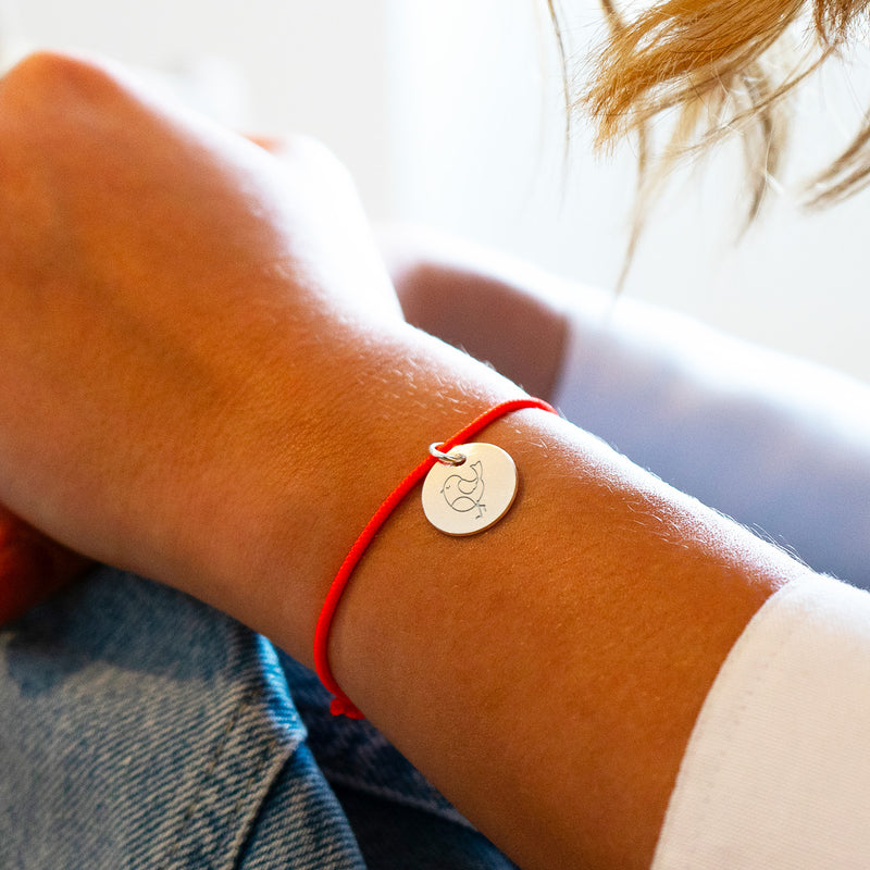 Médaille de 15mm en argent sur cordon orange fluo. L'accessoire parfait pour une tenue estivale éclatante !