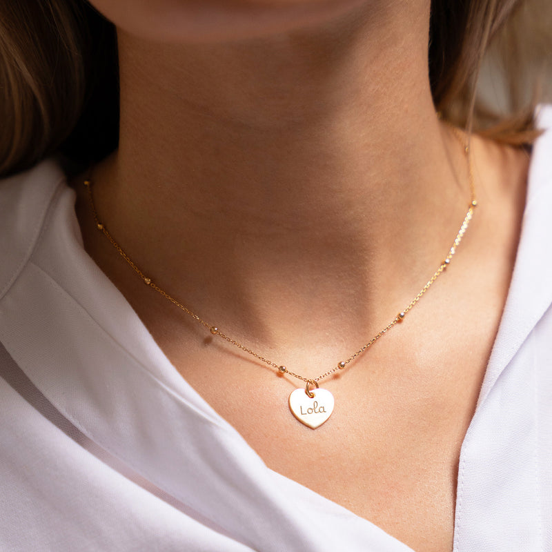 Un pendentif en forme de cœur, de 15 mm, orné d'un placage en or étincelant.