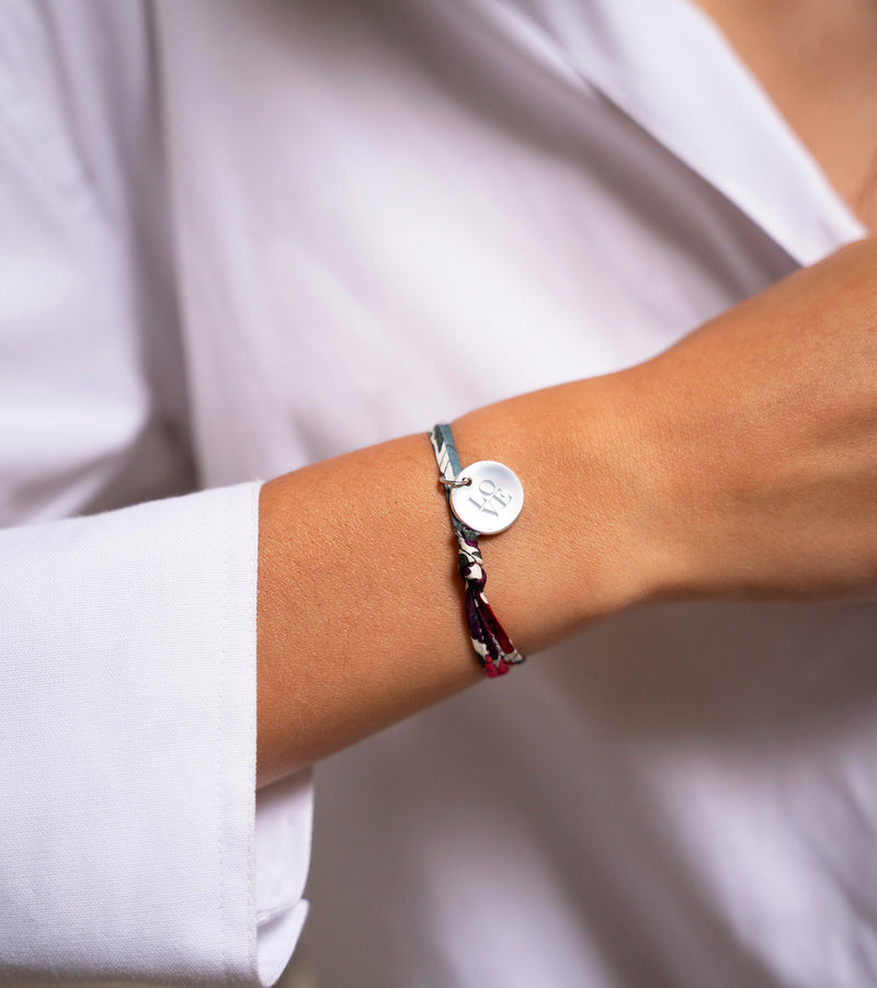 Un bracelet argenté personnalisé, arborant une médaille de 15mm et un délicat lien Liberty Jacinthe.