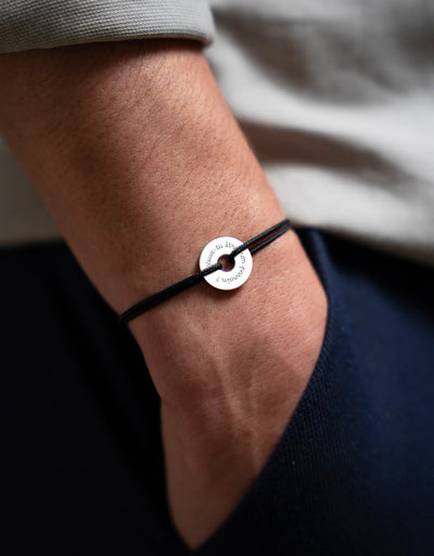 "Un bracelet en forme de cible, personnalisé de 15mm en argent, avec un cordon noir. "