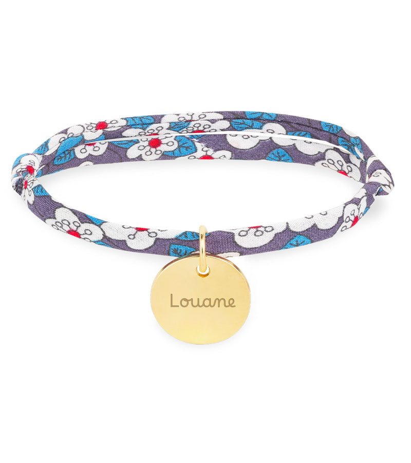 Élégant bracelet avec une médaille plaquée or de 15mm, agrémenté d'un lien Liberty Iris.